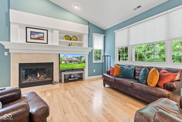 11510 Monon Farms Ln, Carmel, IN 46032 - living area with vaulted ceiling, wood finished floors, a tile fireplace, and baseboards
