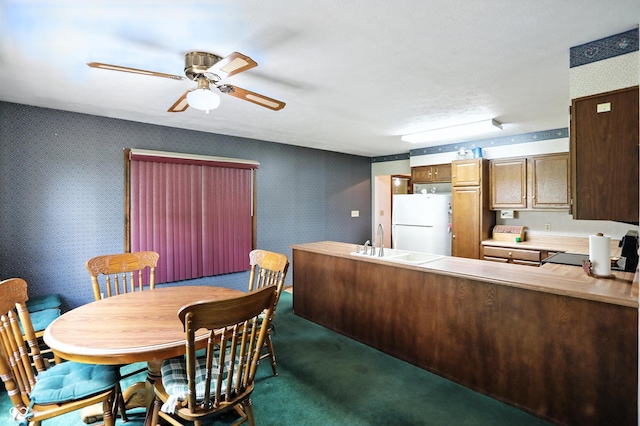 25420 Jerkwater Rd, Sheridan, IN 46069 - kitchen with freestanding refrigerator, wallpapered walls, a ceiling fan, a peninsula, and light countertops