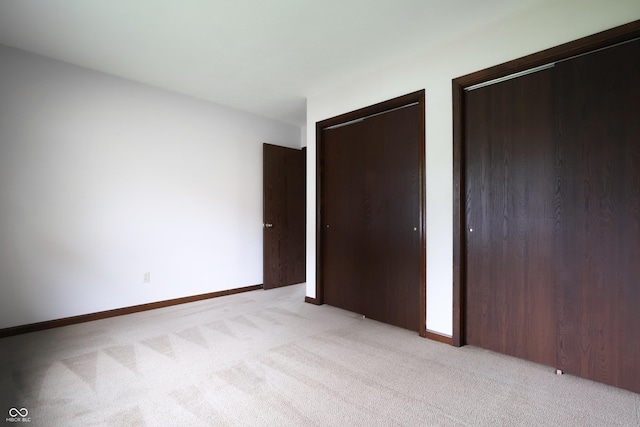 1367 Brookside Ct, Columbus, IN 47201 - unfurnished bedroom with multiple closets and light colored carpet