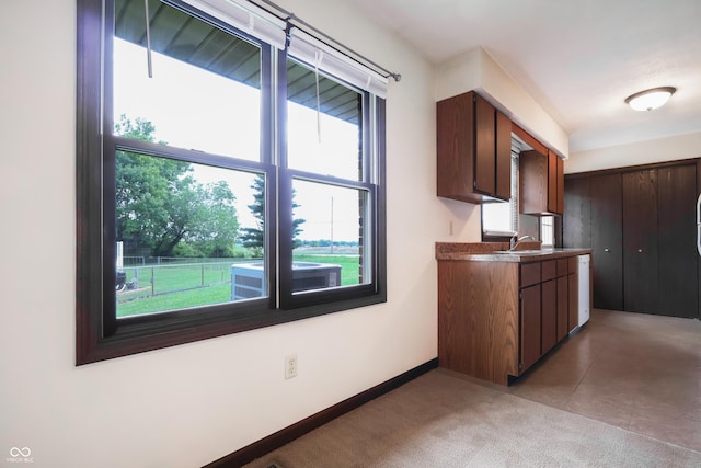 1367 Brookside Ct, Columbus, IN 47201 - kitchen with healthy amount of natural light, a sink, and baseboards
