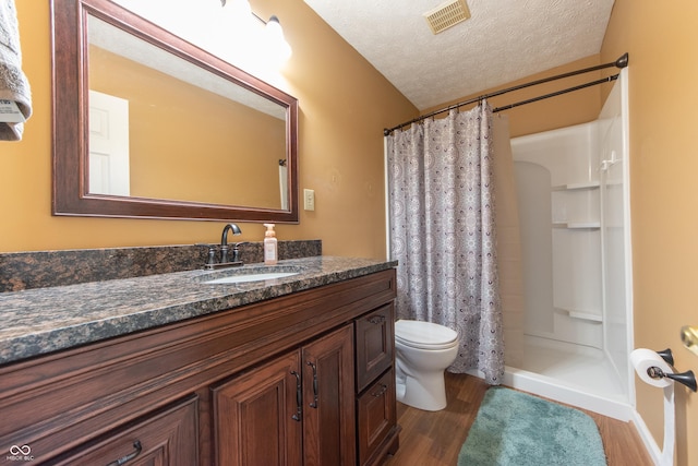 977 Canary Creek Dr, Franklin, IN 46131 - bathroom with wood finished floors, vanity, a textured ceiling, and curtained shower
