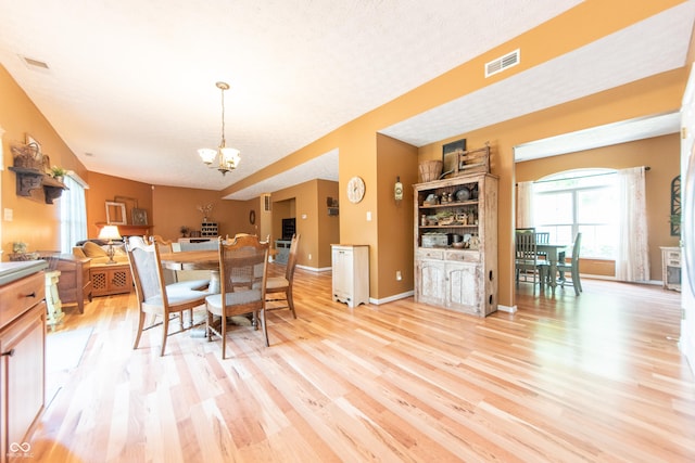 977 Canary Creek Dr, Franklin, IN 46131 - dining space featuring a chandelier, light wood-type flooring, and a textured ceiling