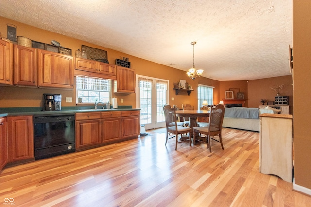 977 Canary Creek Dr, Franklin, IN 46131 - kitchen with black dishwasher, a textured ceiling, light wood-type flooring, a chandelier, and brown cabinets
