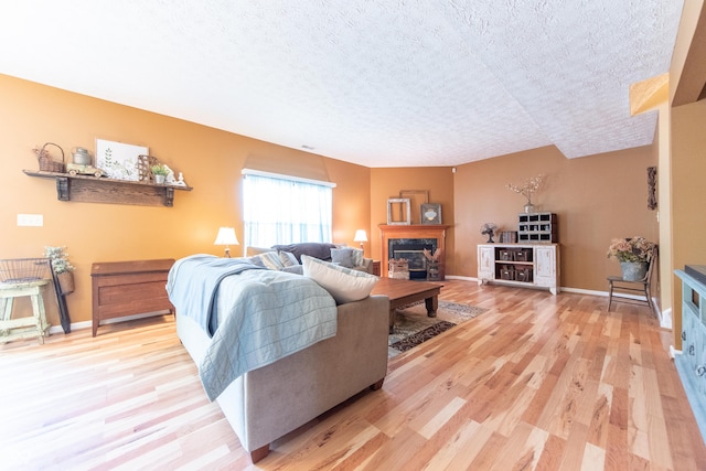 977 Canary Creek Dr, Franklin, IN 46131 - living room with a textured ceiling, light wood-style floors, and a premium fireplace