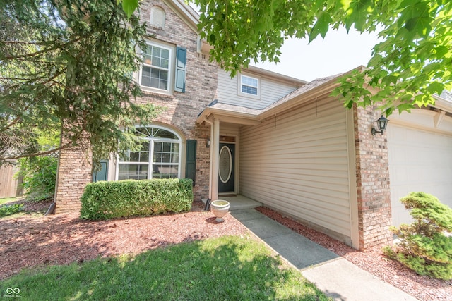 977 Canary Creek Dr, Franklin, IN 46131 - property entrance featuring an attached garage and brick siding