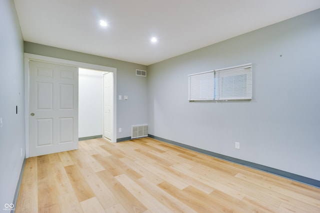 5002 E Washington St, Indianapolis, IN 46201 - unfurnished bedroom with light wood-style floors and recessed lighting