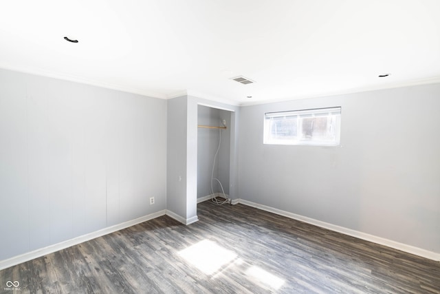 5002 E Washington St, Indianapolis, IN 46201 - unfurnished bedroom featuring dark wood finished floors, ornamental molding, and a closet