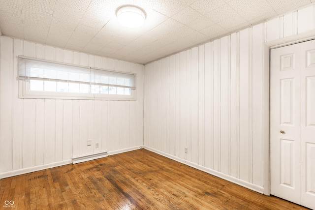 5002 E Washington St, Indianapolis, IN 46201 - unfurnished room with hardwood / wood-style flooring and a baseboard heating unit