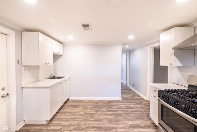 5002 E Washington St, Indianapolis, IN 46201 - kitchen with gas stove, light countertops, light wood-style floors, recessed lighting, and white cabinets