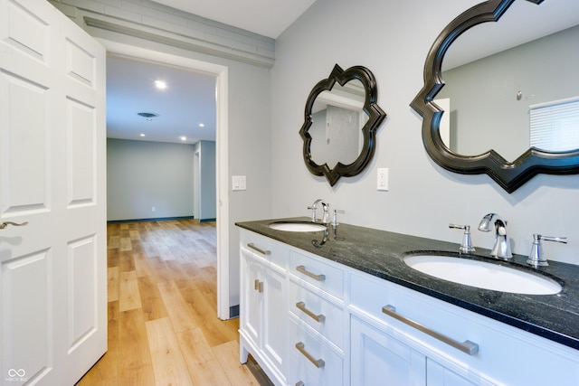 5002 E Washington St, Indianapolis, IN 46201 - full bathroom featuring double vanity, wood finished floors, and recessed lighting