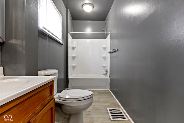 1021 W 37th St, Indianapolis, IN 46208 - bathroom with wood finished floors, vanity, toilet, baseboards, and shower / tub combination