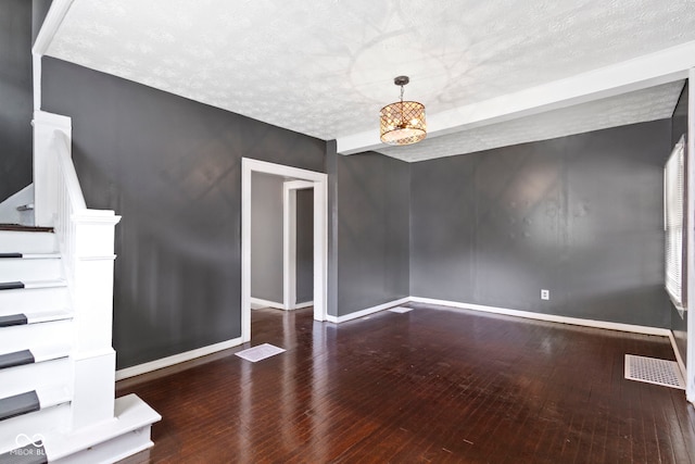 1021 W 37th St, Indianapolis, IN 46208 - spare room featuring wood-type flooring, baseboards, a textured ceiling, and stairway