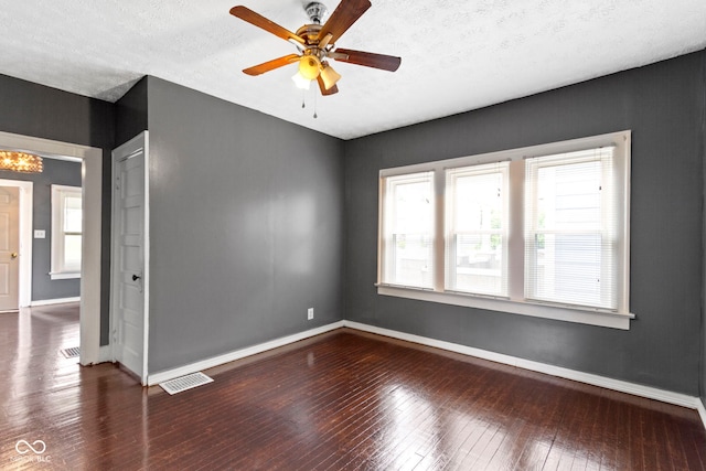 1021 W 37th St, Indianapolis, IN 46208 - empty room with healthy amount of natural light, wood-type flooring, baseboards, and a textured ceiling