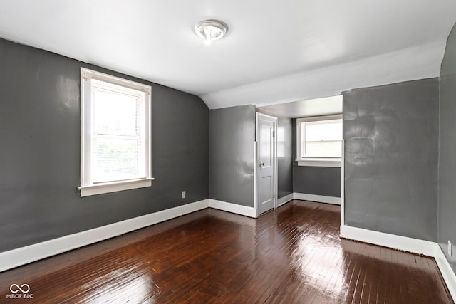 1021 W 37th St, Indianapolis, IN 46208 - empty room featuring vaulted ceiling, dark wood-style floors, and baseboards