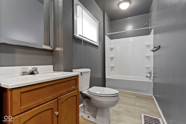 1021 W 37th St, Indianapolis, IN 46208 - full bath with vanity, toilet, washtub / shower combination, and wood finished floors