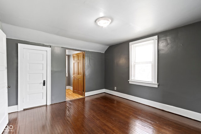 1021 W 37th St, Indianapolis, IN 46208 - unfurnished bedroom featuring wood-type flooring, lofted ceiling, and baseboards