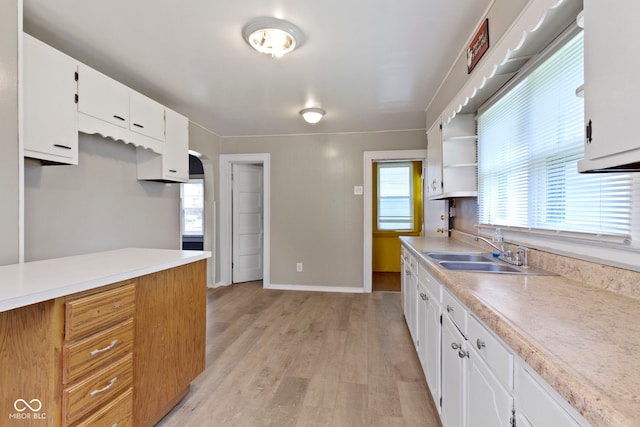 1021 W 37th St, Indianapolis, IN 46208 - kitchen featuring a sink, light wood-style flooring, light countertops, and open shelves