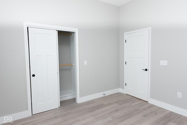 4625 W Naomi St, Indianapolis, IN 46241 - unfurnished bedroom with light wood-style flooring, baseboards, and a closet