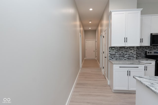 4625 W Naomi St, Indianapolis, IN 46241 - hallway featuring recessed lighting, light wood-type flooring, and baseboards