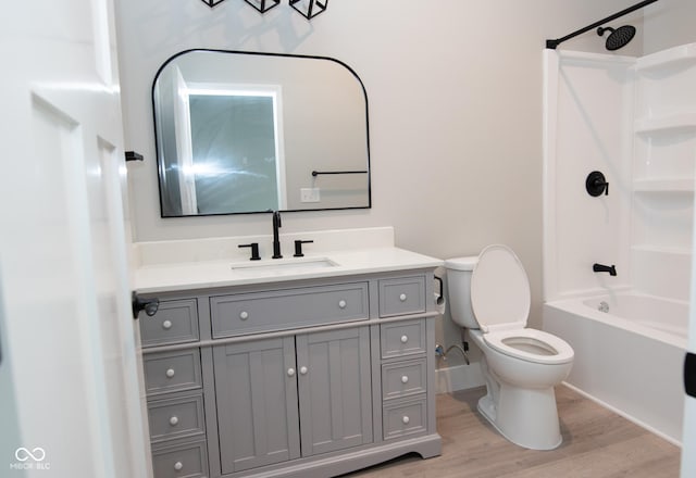 4625 W Naomi St, Indianapolis, IN 46241 - full bathroom featuring toilet, vanity, wood finished floors, washtub / shower combination, and baseboards