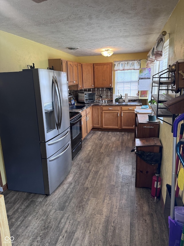 2208 S F St, Elwood, IN 46036 - kitchen with stainless steel fridge with ice dispenser, black electric range oven, dark wood finished floors, a textured ceiling, and brown cabinetry