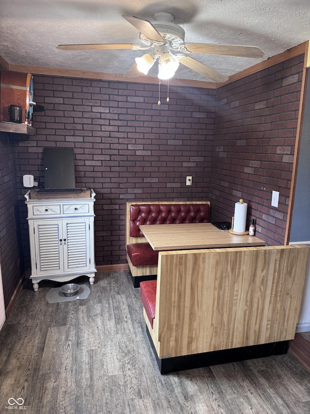 2208 S F St, Elwood, IN 46036 - living room with brick wall, a textured ceiling, ceiling fan, wood finished floors, and baseboards