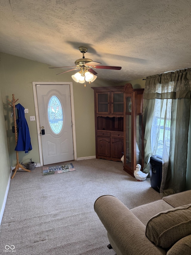 2208 S F St, Elwood, IN 46036 - foyer entrance featuring a ceiling fan, a textured ceiling, light colored carpet, and baseboards