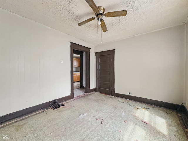 526 N Centennial St, Indianapolis, IN 46222 - spare room featuring a ceiling fan, a textured ceiling, and baseboards
