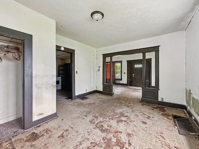 526 N Centennial St, Indianapolis, IN 46222 - unfurnished living room with baseboards and a textured ceiling