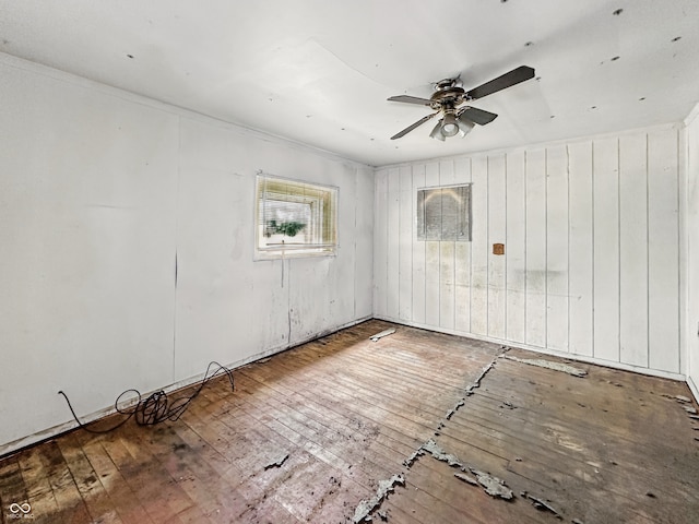 526 N Centennial St, Indianapolis, IN 46222 - empty room with wood-type flooring, ceiling fan, and wooden walls