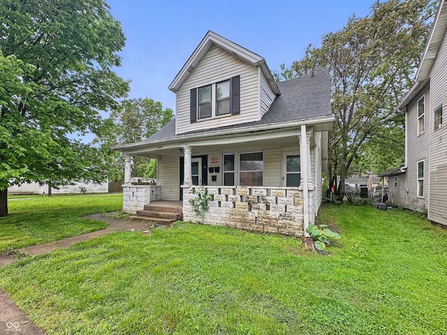526 N Centennial St, Indianapolis, IN 46222 - view of front of home featuring a porch, a front yard, stone siding, and roof with shingles