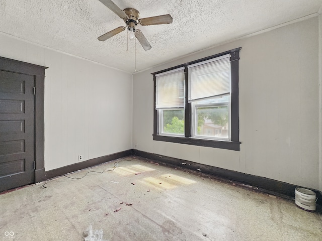 526 N Centennial St, Indianapolis, IN 46222 - spare room with ceiling fan, a textured ceiling, and baseboards
