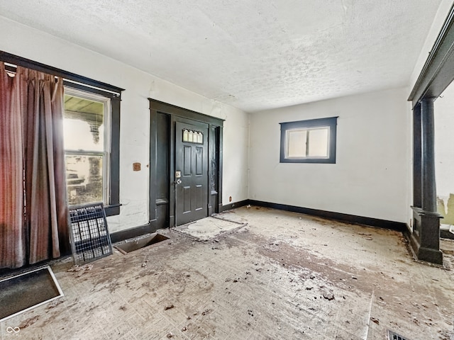 526 N Centennial St, Indianapolis, IN 46222 - entryway with a textured ceiling and baseboards