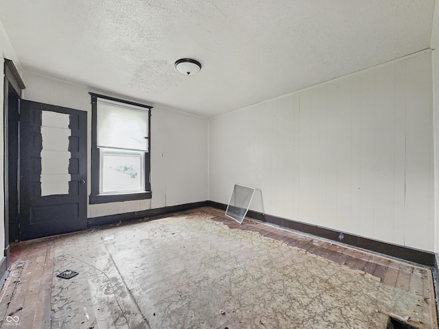 526 N Centennial St, Indianapolis, IN 46222 - unfurnished room with a textured ceiling, baseboards, and hardwood / wood-style floors