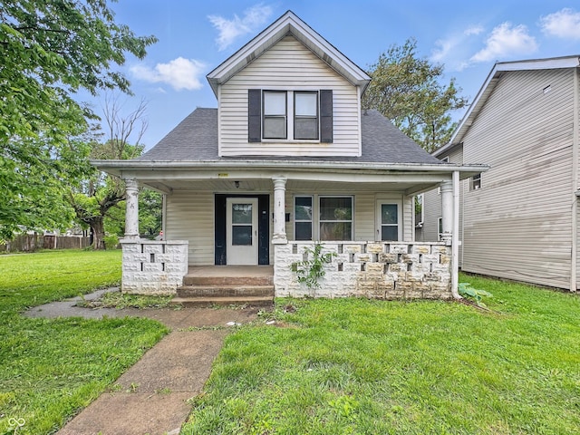 526 N Centennial St, Indianapolis, IN 46222 - bungalow-style house with a porch, a front yard, and a shingled roof