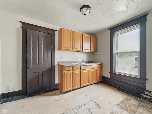 526 N Centennial St, Indianapolis, IN 46222 - kitchen featuring a sink, a textured ceiling, brown cabinets, and light countertops