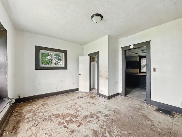 526 N Centennial St, Indianapolis, IN 46222 - unfurnished bedroom with a textured ceiling and baseboards