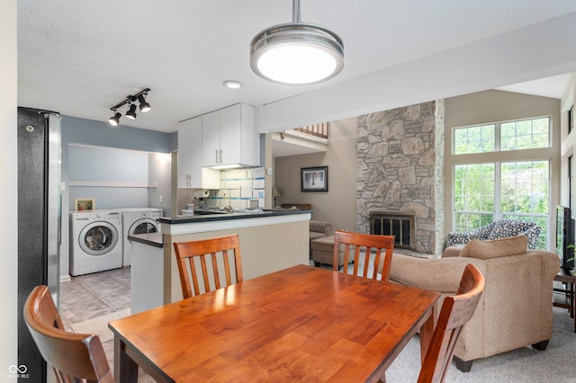 6263 Behner Way, Indianapolis, IN 46250 - dining area with washing machine and dryer and a fireplace