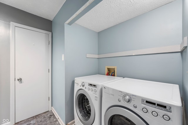 6263 Behner Way, Indianapolis, IN 46250 - laundry room with washing machine and dryer, a textured ceiling, and baseboards