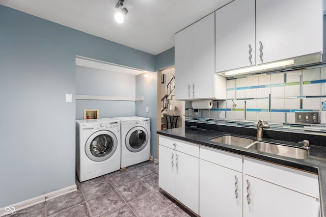 6263 Behner Way, Indianapolis, IN 46250 - laundry room with washing machine and clothes dryer, baseboards, tile patterned flooring, and cabinet space