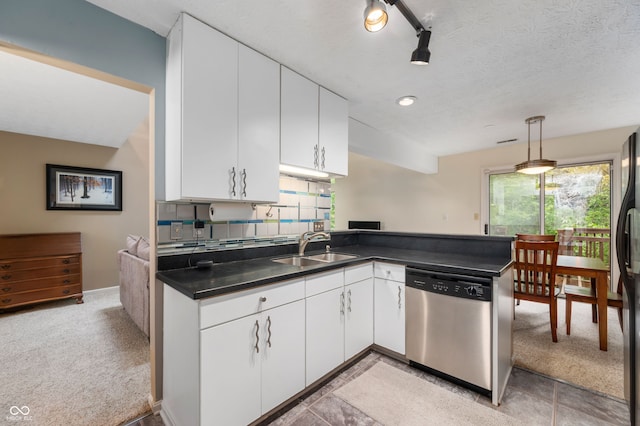 6263 Behner Way, Indianapolis, IN 46250 - kitchen with stainless steel dishwasher, a sink, dark countertops, a peninsula, and white cabinets