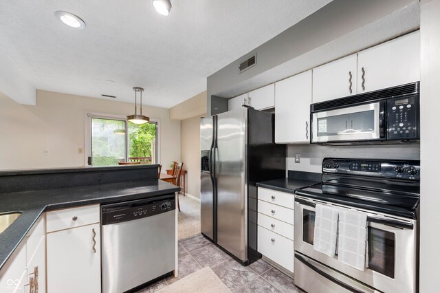 6263 Behner Way, Indianapolis, IN 46250 - kitchen with appliances with stainless steel finishes, white cabinets, dark countertops, light tile patterned floors, and pendant lighting