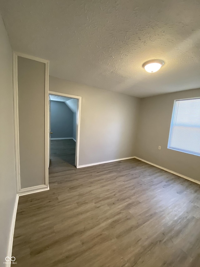 653 Birch Ave, Indianapolis, IN 46221 - unfurnished room with wood finished floors, a textured ceiling, and baseboards