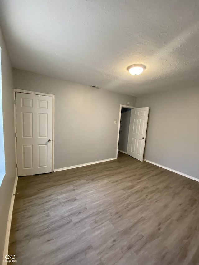 653 Birch Ave, Indianapolis, IN 46221 - spare room with baseboards and wood finished floors