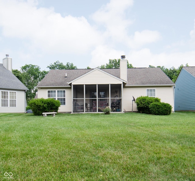540 Cahill Ln, Indianapolis, IN 46214 - rear view of property with a sunroom, a yard, a chimney, and roof with shingles