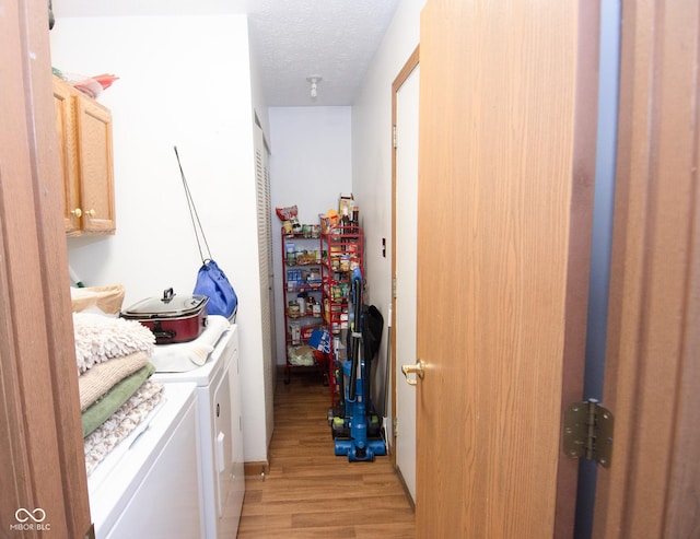 540 Cahill Ln, Indianapolis, IN 46214 - laundry area featuring cabinet space, washing machine and clothes dryer, light wood-type flooring, and a textured ceiling