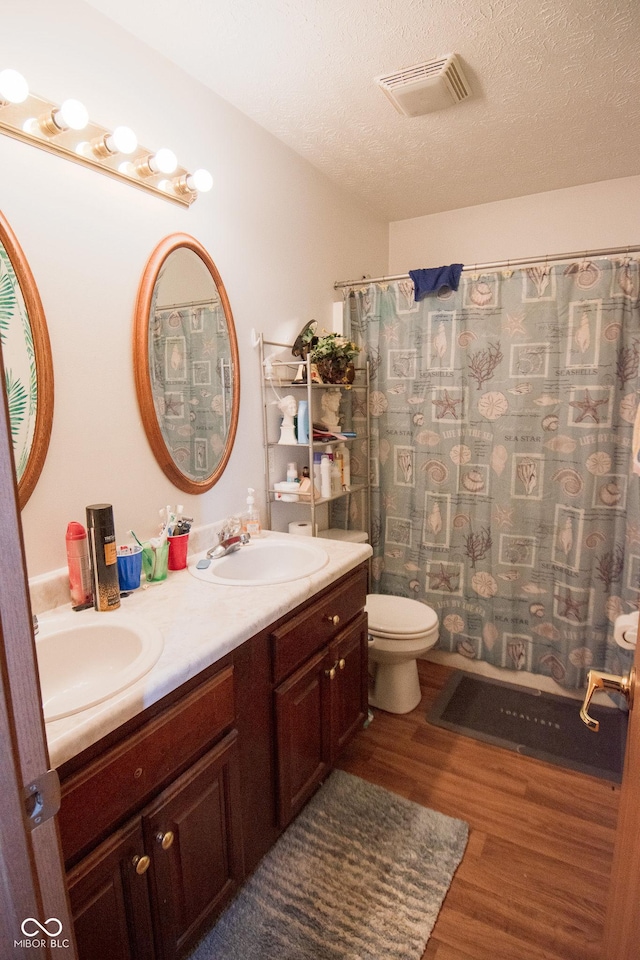 540 Cahill Ln, Indianapolis, IN 46214 - full bath with wood finished floors, double vanity, a textured ceiling, and a shower with curtain