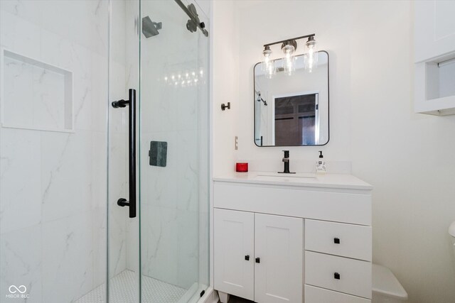 611 N Park Ave Unit 108, Indianapolis, IN 46204 - bathroom with a marble finish shower, vanity, and toilet
