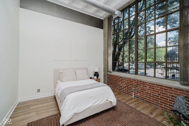 611 N Park Ave Unit 108, Indianapolis, IN 46204 - bedroom with wood finished floors, multiple windows, and baseboards