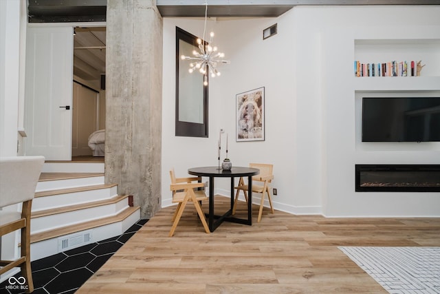 611 N Park Ave Unit 108, Indianapolis, IN 46204 - interior space featuring a chandelier, wood finished floors, and stairway